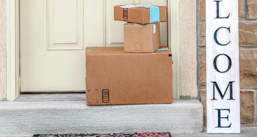 Boxes by the door of a residence with a welcome sign in Columbus